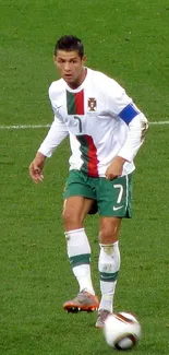 Soccer player in action with green field background.