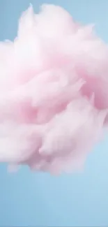Soft pink cotton candy-like cloud on blue background.