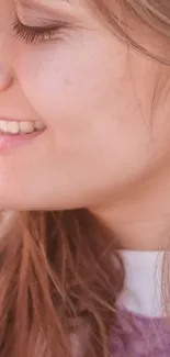 Close-up of a smiling person with light brown hair.