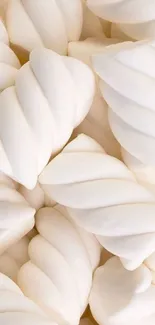 Soft white marshmallows stacked closely together creating a serene background.