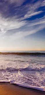 Sunset over the ocean with waves on the beach.