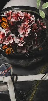 Astronaut helmet filled with flowers and butterflies in a space-themed artwork.