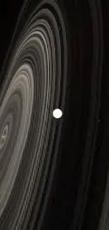 Planetary rings in deep space with a glowing white sphere in the center.