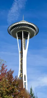 Seattle's Space Needle with blue sky and colorful autumn foliage.