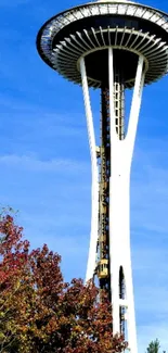 Space Needle with blue sky and autumn trees.