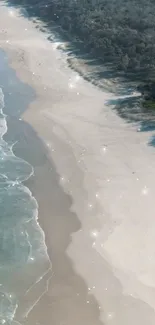 Aerial view of a sparkling beach with blue waves and beige sand.