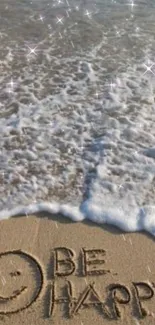 Sandy beach with 'Be Happy' message by the ocean.