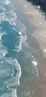 Sparkling turquoise ocean waves on sandy beach.