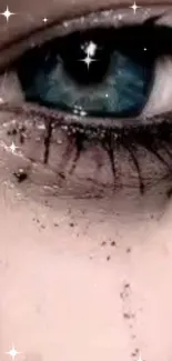 Close-up of a blue eye with glitter and stars, creating a mystical look.