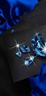 Sparkling blue gemstones on dark luxurious fabric.