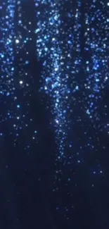 Blue night sky wallpaper with sparkling, glittering stars.