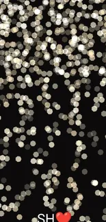 Sparkling bokeh heart wallpaper with black background.