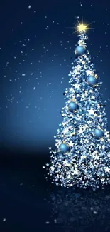 Sparkling Christmas tree with blue ornaments on a dark background.