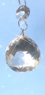 Radiant crystal pendant against a clear blue sky.