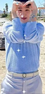 Person in a desert wearing light blue with sparkles, showcasing fashion.