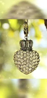 Close-up of a diamond heart pendant hanging from a tree branch.