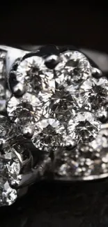 Close-up of a sparkling diamond ring against a dark background.