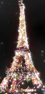 Eiffel Tower at night, aglow with sparkling lights against a black sky.