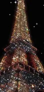 Eiffel Tower adorned in sparkling lights against a black night sky.