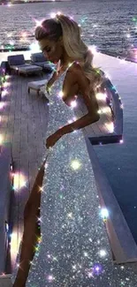 Elegant woman in sparkling dress by the ocean at night.