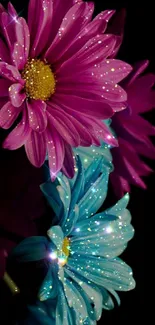 Sparkling pink and blue flowers on a dark background.