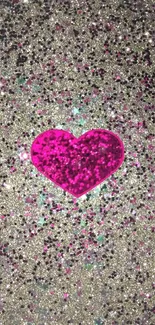 Vibrant pink heart on silver glitter background.