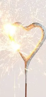 Heart-shaped sparkler with a minimal beige background.