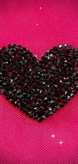 Black sparkling heart on pink textured background wallpaper.