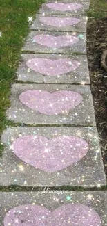 Mobile wallpaper with sparkling pink heart stones on a grassy path.