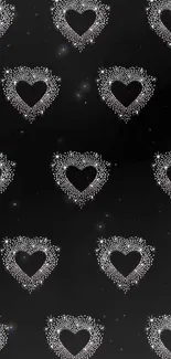 Black wallpaper with sparkling heart pattern design.