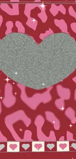 Glittery silver heart on a pink and red patterned background with sparkles.