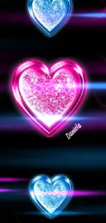 Vibrant wallpaper with sparkling blue and pink hearts on a black background.