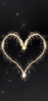 Heart-shaped sparkler on a black background, creating a romantic, glowing effect.