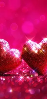 Two glittering red hearts on a pink background.