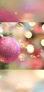 Festive pink ornament with twinkling bokeh lights in the background.