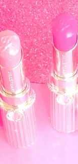 Two elegant pink lipsticks with a sparkling background.