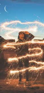 A person holding sparklers under a starry sky with crescent moon.