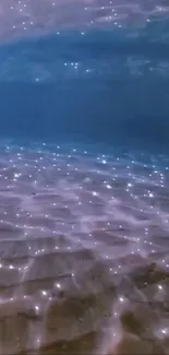 Sparkling ocean floor with shimmering light beneath water.