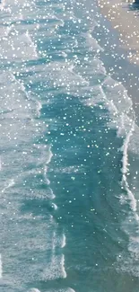 Mobile wallpaper showing sparkling ocean waves and sandy beach.