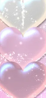 Three shimmering pastel hearts with sparkles on a pink background.