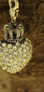 Intricate pendant with sparkling jewels on textured brown background.