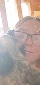 Girl with glasses, sparkling effect, hugging her pet.