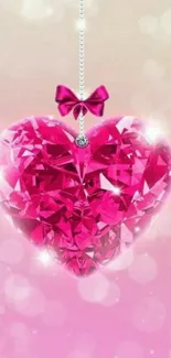 Sparkling pink diamond heart with a bow on a mobile wallpaper background.