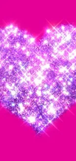 A vibrant pink heart with sparkling glitter effect on mobile wallpaper.