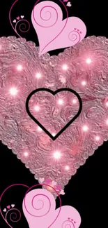 Pink textured heart with sparkling lights on black background.