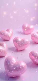 Sparkling pink heart shapes on a soft pastel background.