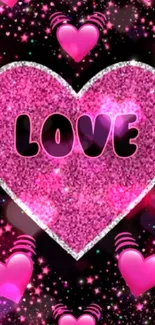 Sparkling pink heart with 'Love' text on black background.