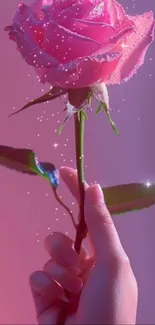 A dewy pink rose with sparkles held by a hand against a soft background.