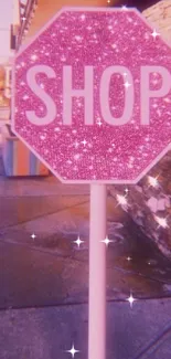 Pink sparkling shop sign in urban setting.