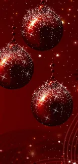 Red Christmas ornaments sparkle on festive mobile wallpaper.